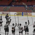 The Kenai River Brown Bears salute seats mostly empty due to coronavirus mitigation measures after a victory over the Chippewa (Wisconsin) Steel on Friday, April 23, 2021, at the Soldotna Regional Sports Complex in Soldotna, Alaska. (Photo by Jeff Helminiak/Peninsula Clarion)