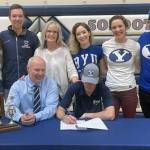 Soldotna senior Dylan Walton signs his National Letter of Intent as his family looks on recently at Soldotna High School in Soldotna, Alaska. (Photo by Jeff Helminiak/Peninsula Clarion)