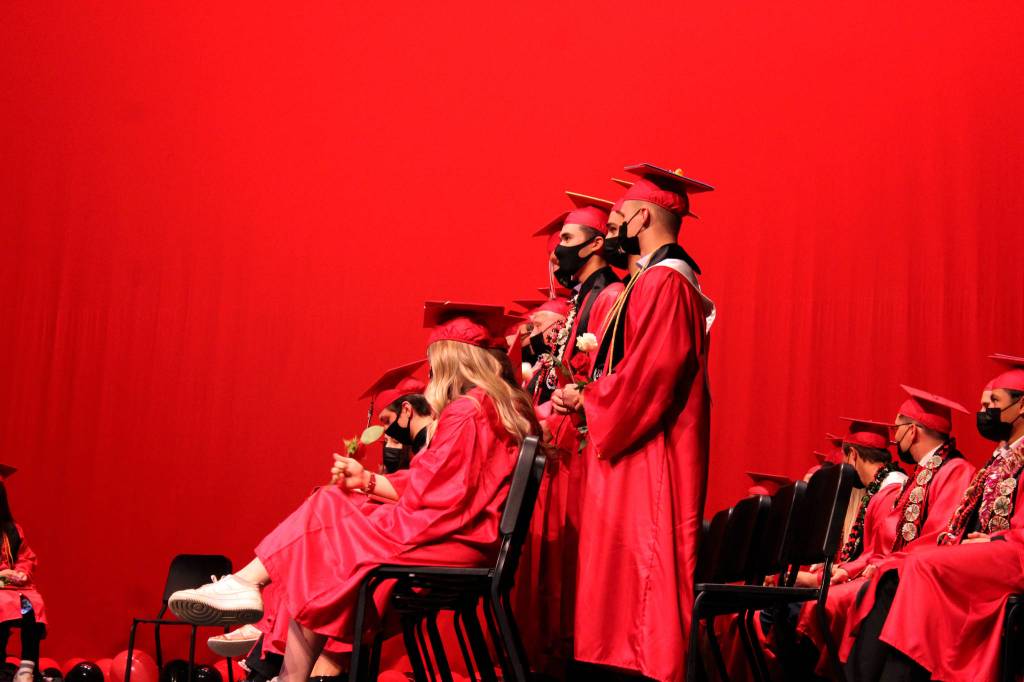 Graduates hold roses during Kenai Central High Schools 2021 graduation ceremony on Monday, May 17, 2021 in Kenai, Alaska. (Ashlyn OHara/Peninsula Clarion)
