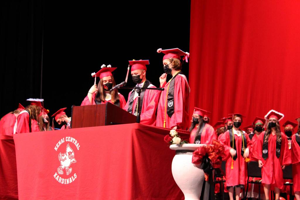 Rachael Pitsch (left), Owen Rolph (center) and Abigail Moffett lead students in the turning of the tassels during graduation at Kenai Central High School on Monday, May 17 in Kenai, Alaska. (Ashlyn OHara/Peninsula Clarion)