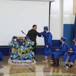 Kenai Alternative High School Principal Loren Reese bumps elbows with graduates during their 2021 graduation ceremony on Tuesday, May 18, 2021 in Kenai, Alaska. (Ashlyn OHara/Peninsula Clarion)