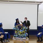 Loren Reese helps adjust Alivia Howards microphone during Kenai Alternative High Schools 2021 graduation ceremony on Tuesday, May 18, 2021 in Kenai, Alaska. (Ashlyn OHara/Peninsula Clarion)