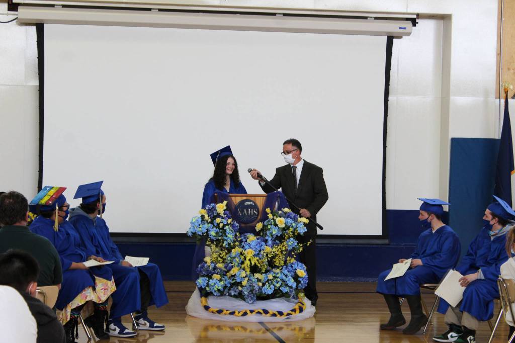 Loren Reese helps adjust Alivia Howards microphone during Kenai Alternative High Schools 2021 graduation ceremony on Tuesday, May 18, 2021 in Kenai, Alaska. (Ashlyn OHara/Peninsula Clarion)