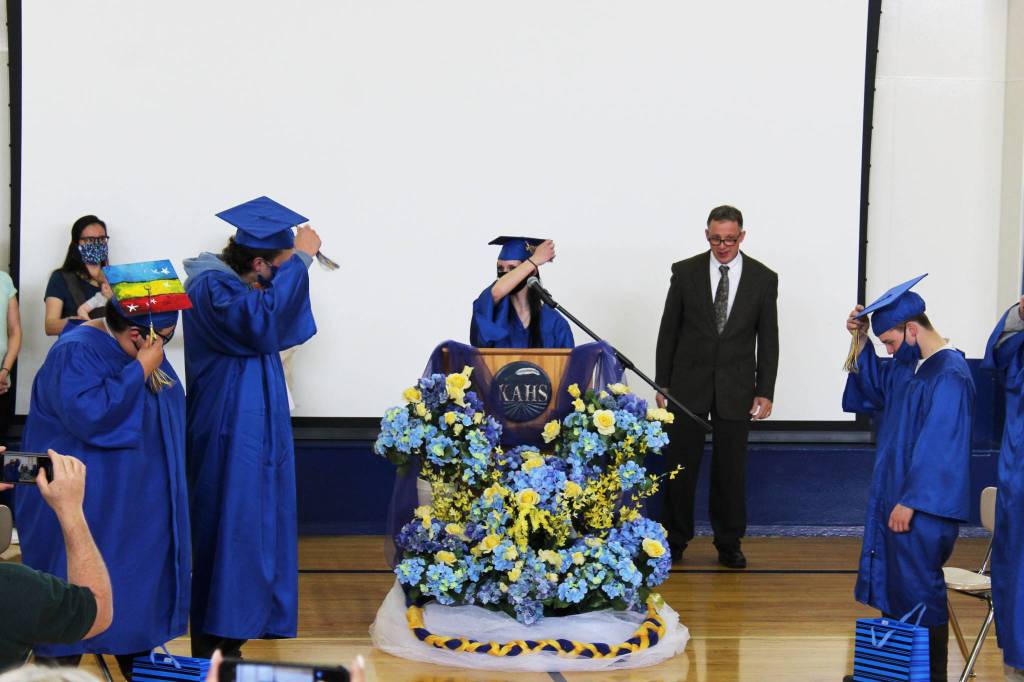 Brianna Mosiman (center) leads Kenai Alternative High School Graduates in turning their graduation cap tassels during Kenai Alternative High Schools 2021 graduation ceremony on Tuesday, May 18, 2021 in Kenai, Alaska. (Ashlyn OHara/Peninsula Clarion)