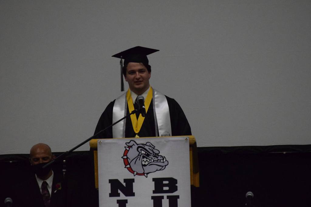 Salutatorian Brenden Boehme gives his commencement address at the Nikiski Middle/High School graduation on Wednesday, May 19, 2021 in the gymnasium. (Camille Botello / Peninsula Clarion)