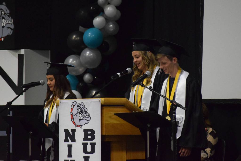 Valedictorians Rosalie Anderson, Lillian Carstens and Samuel Smith give their commencement address at the Nikiski Middle/High School graduation on Wednesday, May 19, 2021 in the gymnasium. (Camille Botello / Peninsula Clarion)