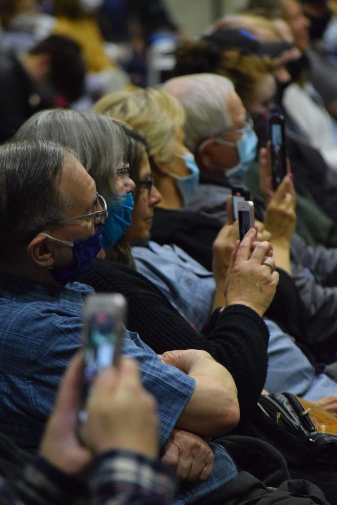 Spectators take videos of the graduates at the Nikiski Middle/High School commencement ceremony on Wednesday, May 19, 2021. (Camille Botello / Peninsula Clarion)