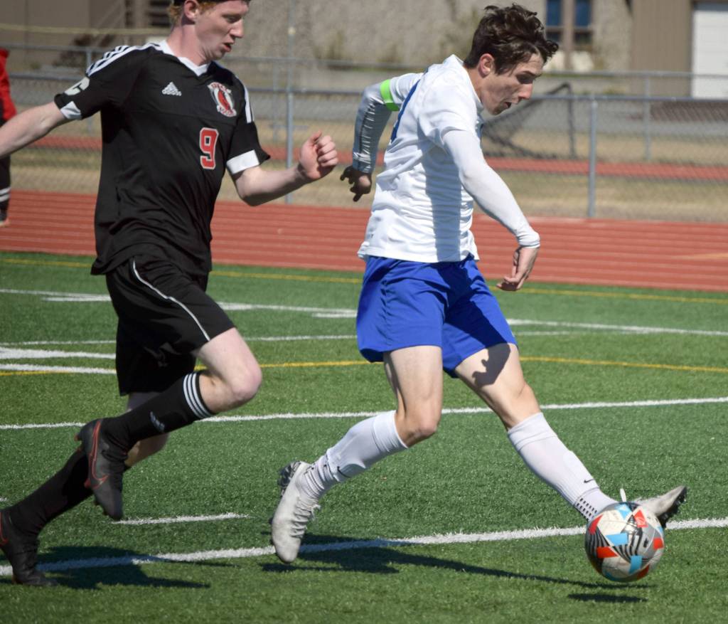 Soldotnas Josh Hieber gets past Kenais Joe Hamilton to score Saturday, May 22, 2021, in the Peninsula Conference final at Kenai Central High School in Kenai, Alaska. (Photo by Jeff Helminiak/Peninsula Clarion)