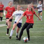 Homers Kappa Reutov and Kenais Julia Hansen battle for the ball Friday, May 21, 2021 at the Peninsula Conference tournament at Kenai Central High School in Kenai, Alaska. (Photo by Jeff Helminiak/Peninsula Clarion)
