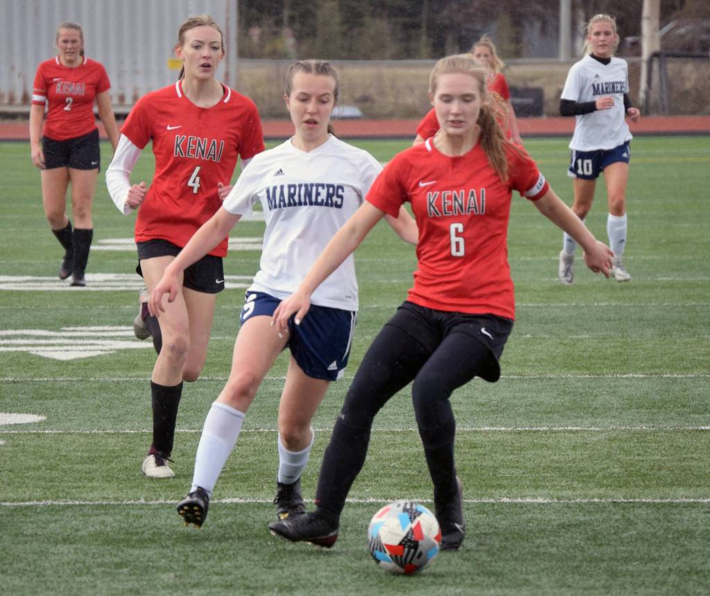 Homers Kappa Reutov and Kenais Julia Hansen battle for the ball Friday, May 21, 2021 at the Peninsula Conference tournament at Kenai Central High School in Kenai, Alaska. (Photo by Jeff Helminiak/Peninsula Clarion)