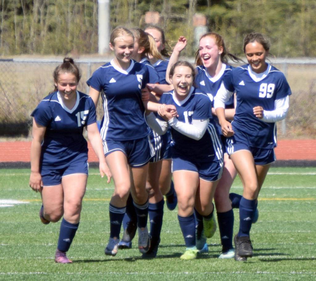Soldotna congratulates Jolie Widaman (5) after she scored in the first half of the Peninsula Conference final Saturday, May 22, 2021, at Kenai Central High School in Kenai, Alaska. (Photo by Jeff Helminiak/Peninsula Clarion)