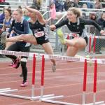 Soldotnas Angelina Chavarria and Emma Brantley clear a hurdle during the Division I girls 100-meter hurdles in the Region 3 Championshps on Saturday, May 22, 2021, at Wasilla High School. (Photo by Jeremiah Bartz/Frontiersman)