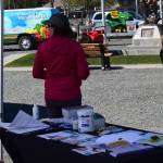 A nurse with Kenai Public Health encourages people to get their COVID-19 vaccines during the first day of the Wednesday Market in Soldotna, Alaska, on Wednesday, May 26, 2021. (Camille Botello / Peninsula Clarion)