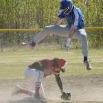 Palmers Owen Hayes jumps over Kenai pitcher Simon Grenier. Hayes was able to take third base safely for a triple Thursday, May 27, 2021, at the Southcentral Conference tournament at the Soldotna Little League fields in Soldotna, Alaska. (Photo by Jeff Helminiak/Peninsula Clarion)