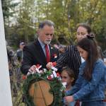 Alaska Senate President Peter Micciche (R-Soldotna) lays a poppy flower on a remberance wreath with his family during the Memorial Day ceremony at Leif Hansen Memorial Park in Kenai, Alaska, on Monday, May 31, 2021. (Camille Botello/Peninsula Clarion)