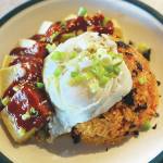A fried egg, crushed seaweed paper, green onions and sesame seeds top this classic Korean kimchi dish. (Photo by Tress Dale/Peninsula Clarion)