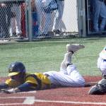 Mylan Johnson slides head first into home plate to score for Homer at the Division II state baseball tournament in Wasilla on Saturday. (Camille Botello / Peninsula Clarion)