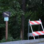 A sign and road blocker at the head of the Hidden Creek Trail on Skilak Lake Road warns people about bear activity on Sunday, June 13, 2021 in Alaska. (Ashlyn OHara/Peninsula Clarion)