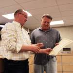 Brent Hibbert (left) presents Tim Dillon (right) with a commending resolution on Tuesday, June 15, 2021 in Soldotna, Alaska. (Ashlyn OHara/Peninsula Clarion)