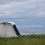 A tent is set up at the Kasilof River State Recreational Site in Kasilof, Alaska, on Friday, June 25, 2021. The Kasilof River dipnet opening yields anglers from all over the state. (Camille Botello / Peninsula Clarion)