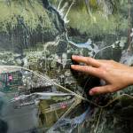 Stephanie Presley, program lead for the Seward-Bear Creek Flood Service Area, points at a map of Seward and the location of Sewards schools, which sit near Japanese Creek in Seward, Alaska. (Young Kim for The Hechinger Report)