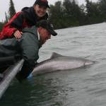 Greg Brush, center, passes Kenai conservation on to the next generation of anglers by releasing a king salmon. (Photo courtesy Greg Brush)