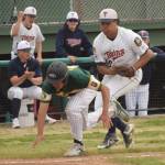 Twins third baseman Atticus Gibson tags out Services Coen Niclai in a rundown Thursday at Coral Seymour Memorial Park in Kenai. (Photo by Jeff Helminiak/Peninsula Clarion)