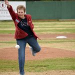 Nikiskis Sue Coup throws out the first pitch at a ceremony honoring former Twins head coach and general manager Lance Coz on Saturday at Coral Seymour Memorial Park in Kenai. (Photo by Jeff Helminiak/Peninsula Clarion)