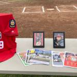 A table of momentos honors former American Legion Twins manager and head coach Lance Coz on Saturday at Coral Seymour Memorial Park in Kenai. (Photo by Jeff Helminiak/Peninsula Clarion)