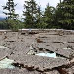 Insulation can be seen through broken shingles on the Novatney Buildings roof. Funding for maintenance work on the roof was among Gov. Mike Dunleavys over $215 million in budget cuts. Design work for the effort has long been completed, said UAS facilities maintenance and operations manager Adam Zenger. The roof does not currently leak, he said, but in light of roofs condition he said theres concern that could change. (Ben Hohenstatt / Juneau Empire)