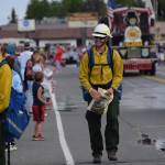 Officials with the Smokey Bear float hand out bracelets during Kenais annual Fourth of July parade on July 4, 2021. (Camille Botello / Peninsula Clarion)