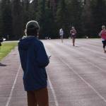 Kenai Watershed Forum Stream Watch Interns Brandom Drzazgowski and Jack Buban record 5K times of participants in the first race of the Salmon Run Series at the Skyview Middle School track on Wednesday, July 7, 2021. (Camille Botello / Peninsula Clarion)