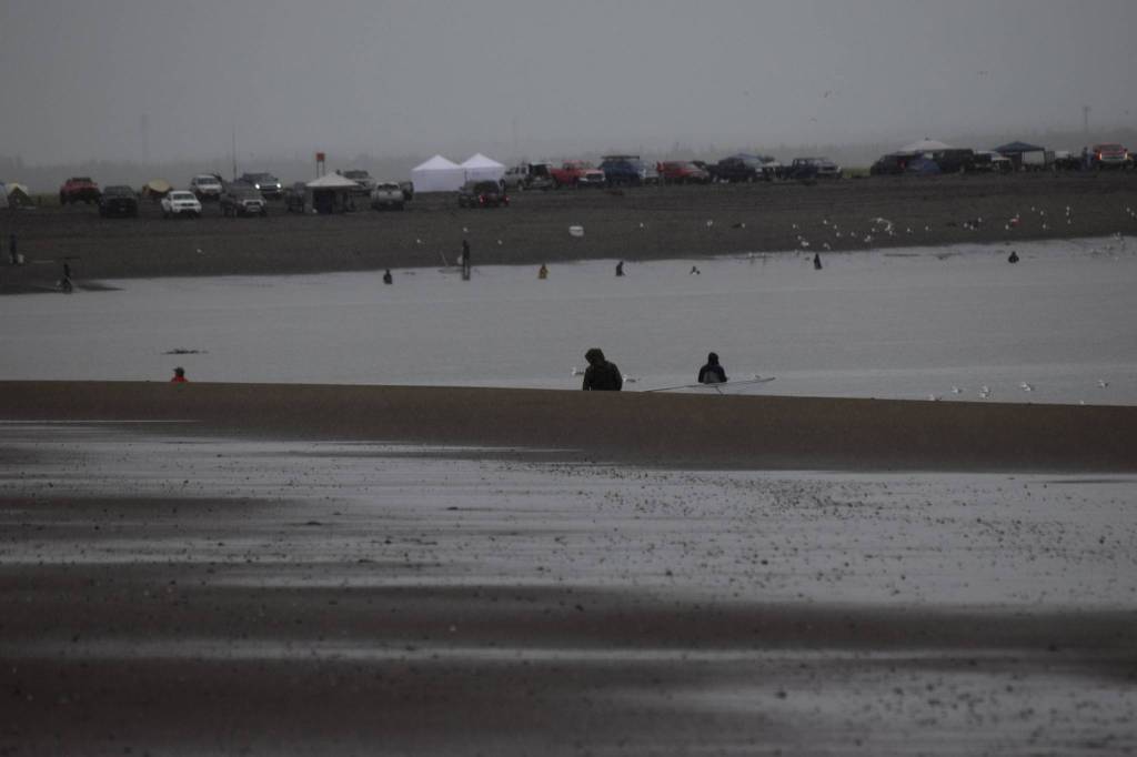 Fishers dipnet in the mouth of the Kenai River on Saturday, July 10, 2021. (Camille Botello / Peninsula Clarion)