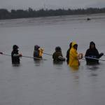 Dipnetters make a line in the waters off North Kenai Beach on Saturday, July 10, 2021. (Camille Botello / Peninsula Clarion)