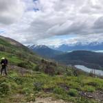 A hiker heads down Skyline Trail from the saddle near Cooper Landing, Alaska on June 27, 2021. (Camille Botello / Peninsula Clarion)