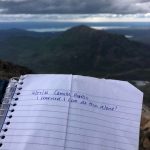 Camille Botello signs the lock-box book at the peak of the Skyline Trail on June 27, 2021. (Camille Botello / Peninsula Clarion)