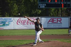 Oilers pitcher Liam Rocha fires off a pitch during the teams home game against the Chugiak Chinooks on July 13, 2021, at Coral Seymour Memorial Ball Park in Kenai, Alaska. (Camille Botello / Peninsula Clarion)