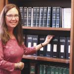 Ashlyn OHara / Peninsula Clarion
Colette Thompson stands near a bookshelf in her office Thursday at the George A. Navarre Borough Building in Soldotna.