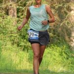 Shelby Dykstra, of Soldotna, runs to victory in the 10-kilometer event at the Rotary Unity Run on Saturday, July 17, 2021, at Tsalteshi Trails just outside of Soldotna, Alaska. (Photo by Jeff Helminiak/Peninsula Clarion)