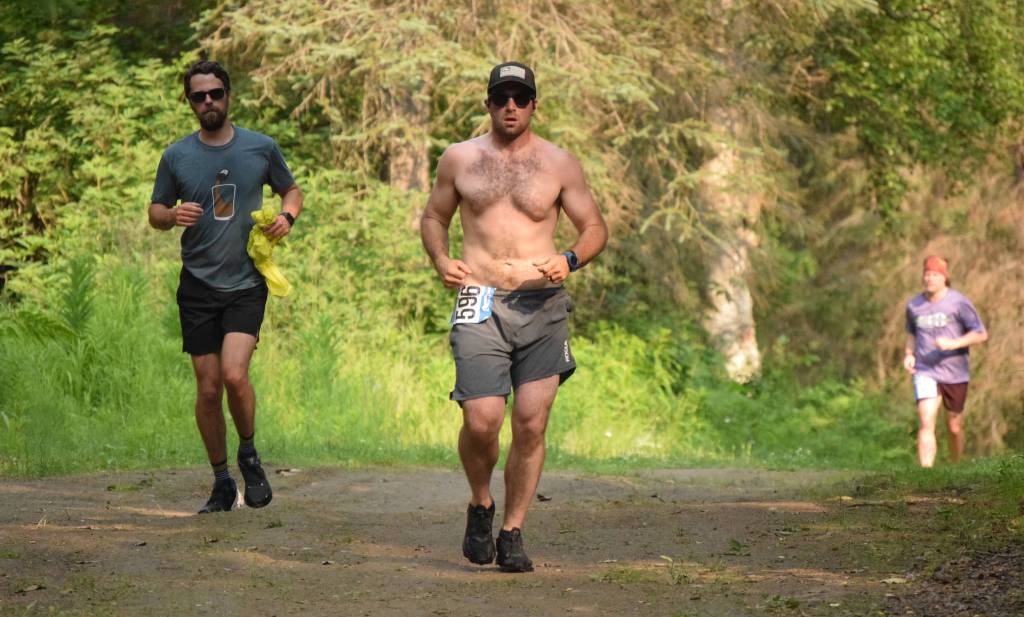 Elias Wheeler, of Soldotna, leads fellow 10K runners at the Rotary Unity Run at Tsalteshi Trails just outside of Soldotna, Alaska, on Saturday, July 17, 2021. (Photo by Jeff Helminiak/Peninsula Clarion)