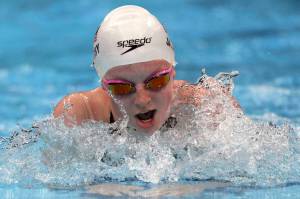 Lydia Jacoby of the United States swims in a heat during the women's 100-meter breaststroke at the 2020 Summer Olympics, Sunday, July 25, 2021, in Tokyo, Japan. (AP Photo/Matthias Schrader)