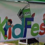 Peninsula Community Health Services distributes backpacks in a school supply drive through at the KidFest event on Wednesday, Aug. 4, 2021 in Kenai, Alaska. (Camille Botello/Peninsula Clarion)