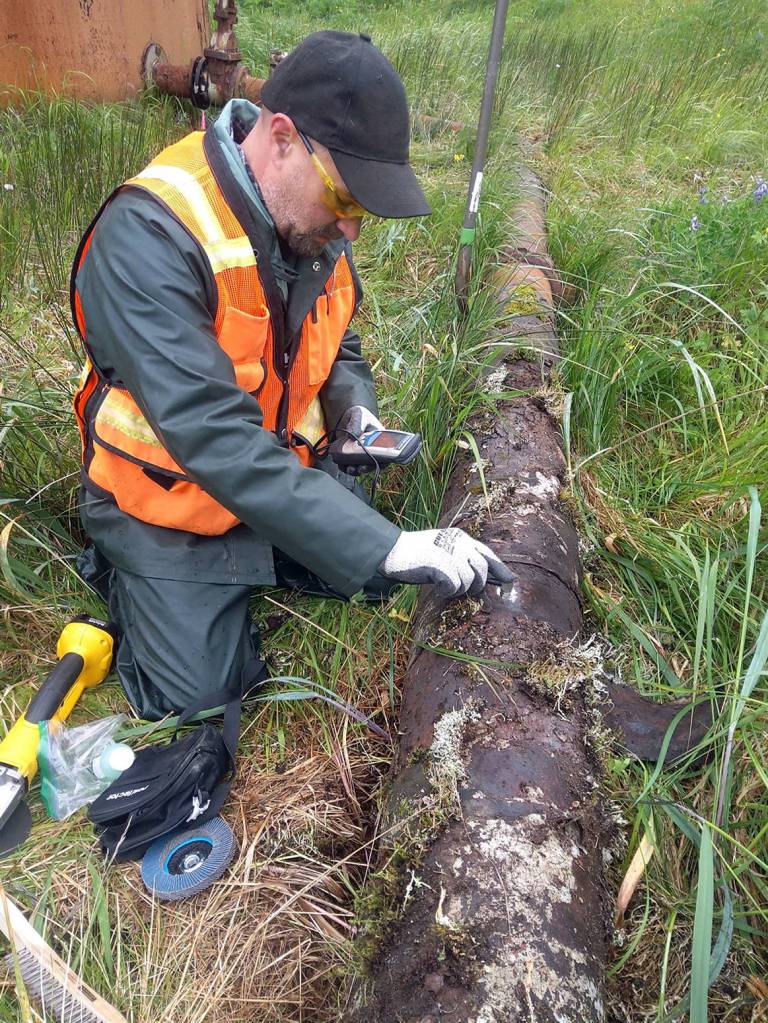 A network of underground pipes transported diesel fuel from storage tanks to the fueling pier. Inspectors carefully drilled in to see what contaminants may still be inside. (USFWS)