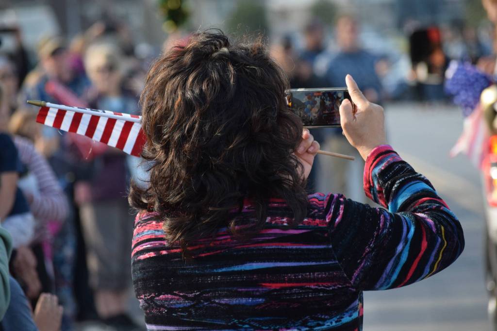 The crowd cheers and takes photos as Olympic gold medalist Lydia Jacoby passes through Seward during her celebratory parade on Thursday, August 5, 2021. (Camille Botello / Peninsula Clarion)