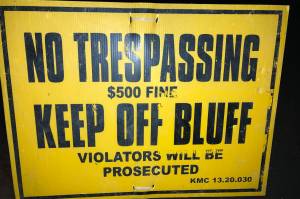 A sign at North Kenai Beach warns pedestrians away from the eroding bluffs. (Photo by Jeff Helminiak/Peninsula Clarion)