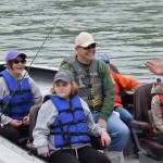 Participants in the Kenai River Junior Classic head down the Kenai River near Big Eddy Road in Soldotna, Alaska, on Wednesday, Aug. 11, 2021. (Camille Botello/Peninsula Clarion)