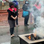 Michael S. Lockett / Juneau Empire
Lily Hope, daughter of famed artist and weaver Clarissa Rizal, watches the burning of a commercial garment at the center of a ceremony commemorating the settlement in an intellectual property lawsuit against a fashion company on Friday, Aug. 13, 2021.