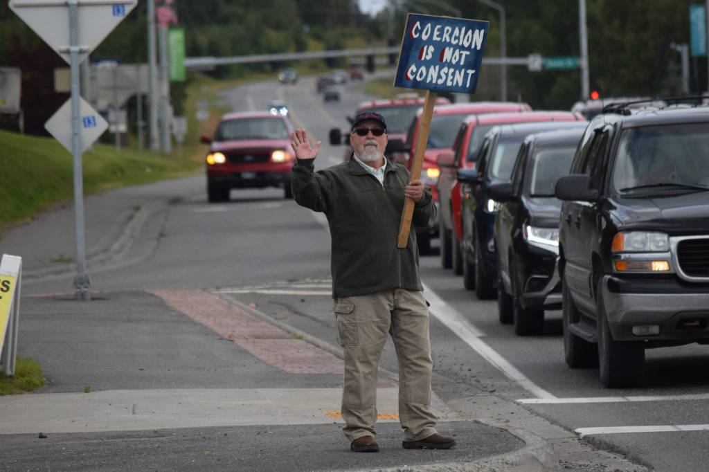 Kevin Hall stands at the Y intersection of the Kenai Spur and Sterling highways in Soldotna on Saturday, Aug. 14 to protest mandatory COVID-19 vaccines and mitigation protocols. (Camille Botello/Peninsula Clarion)
