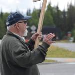 Kevin Hall stands at the Y intersection of the Kenai Spur and Sterling highways in Soldotna on Saturday, Aug. 14 to protest mandatory COVID-19 vaccines and mitigation protocols. (Camille Botello/Peninsula Clarion)
