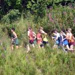Homers Seamus McDonough leads a pack early in the boys varsity race at the Ted McKenney XC Invitational on Saturday, Aug. 21, 2021, at Tsalteshi Trails just outside of Soldotna, Alaska. McDonough finished ninth in the race. (Photo by Jeff Helminiak/Peninsula Clarion)